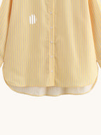 Yellow striped shirt on a light gray background