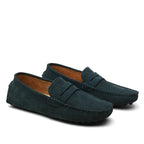 Pair of dark green loafers on a white background
