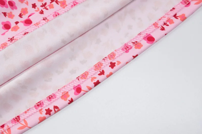 Close-up of pink floral fabric with a white background