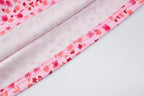 Close-up of pink floral fabric with a white background