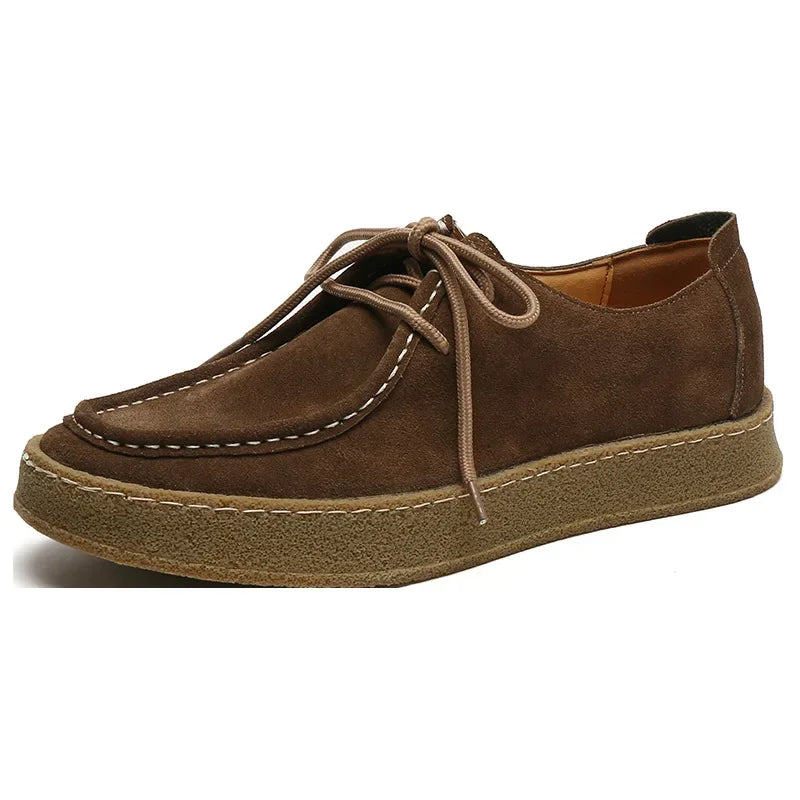 Brown suede shoe on a white background