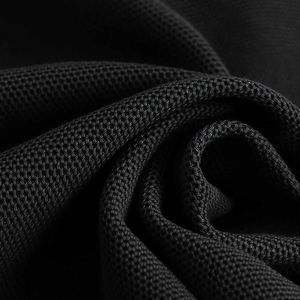 Close-up of textured black fabric with a dark background