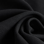 Close-up of textured black fabric with a dark background