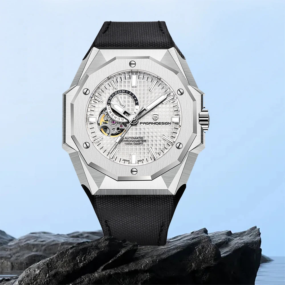 Luxury watch with a black strap on a rocky surface with a light blue background