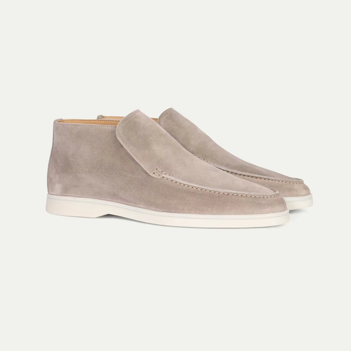 Pair of beige suede shoes on a white background
