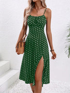 Woman wearing a green polka dot dress with a white background