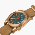 Wristwatch with bronze case and strap on a white background