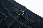 Close-up of a blue denim pocket with a metal button on a white background