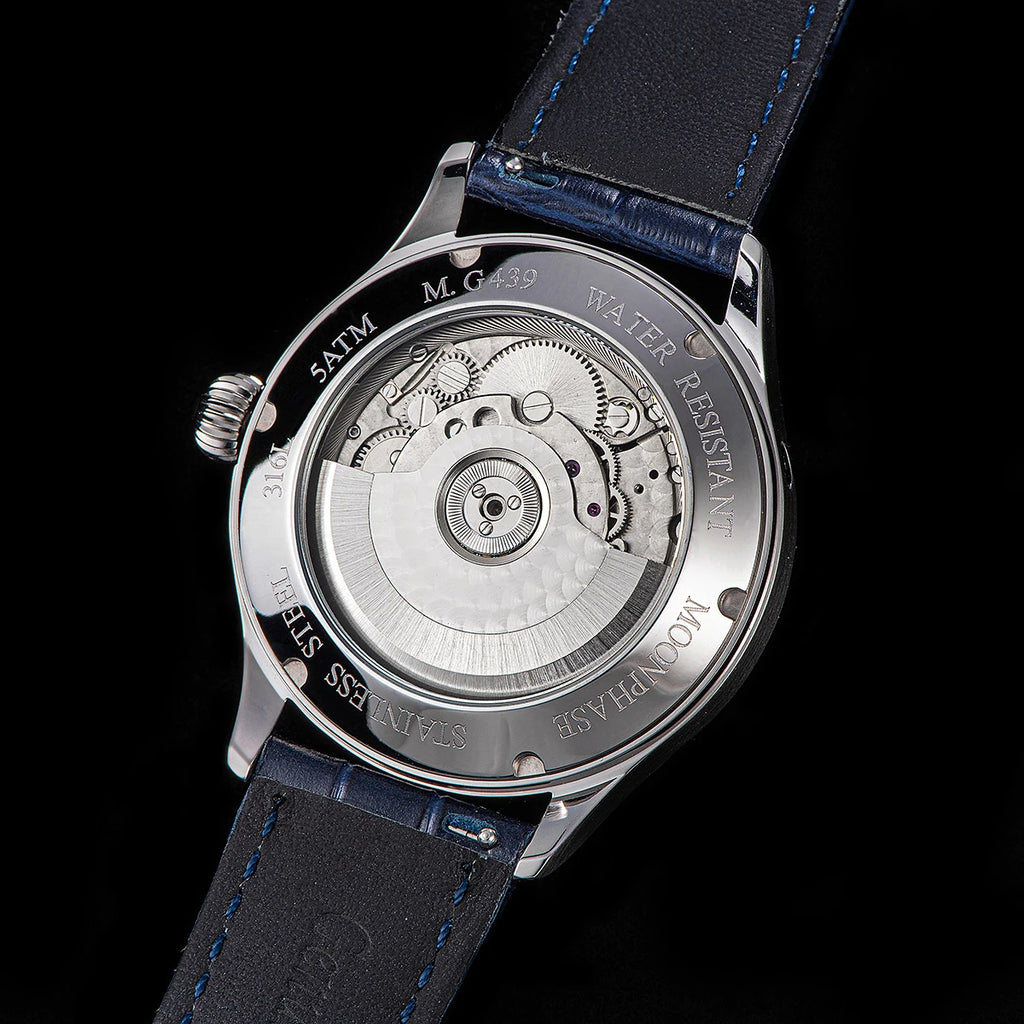 Watch back cover with mechanical components on a black background