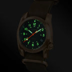 Watch with green and red glowing digits on a dark background