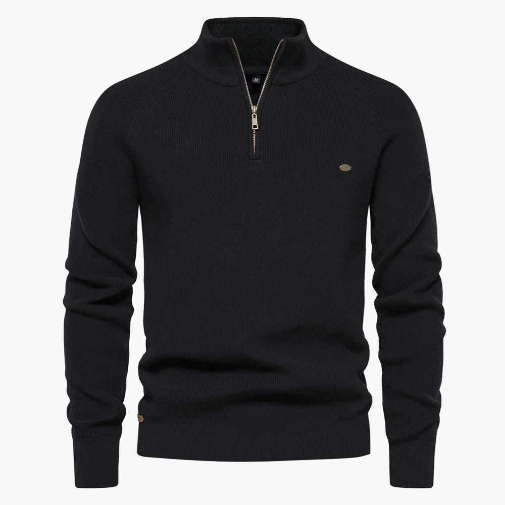 Black sweater with a gold zipper on a white background