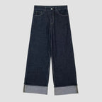 Dark blue wide-leg jeans with cuffed hems on a white background