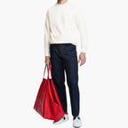 Person holding a red bag with a white background