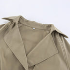 Close-up of a beige trench coat on a white background