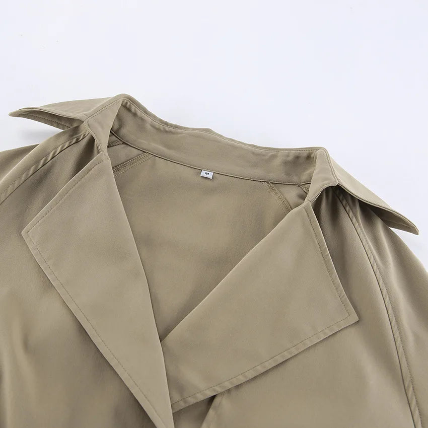 Close-up of a beige trench coat on a white background