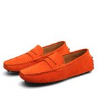 Pair of orange loafers on a white background