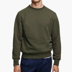 Person wearing a green sweatshirt on a white background