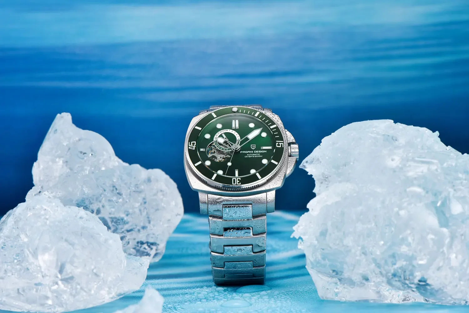 Watch with green face and silver case on a blue background with ice cubes
