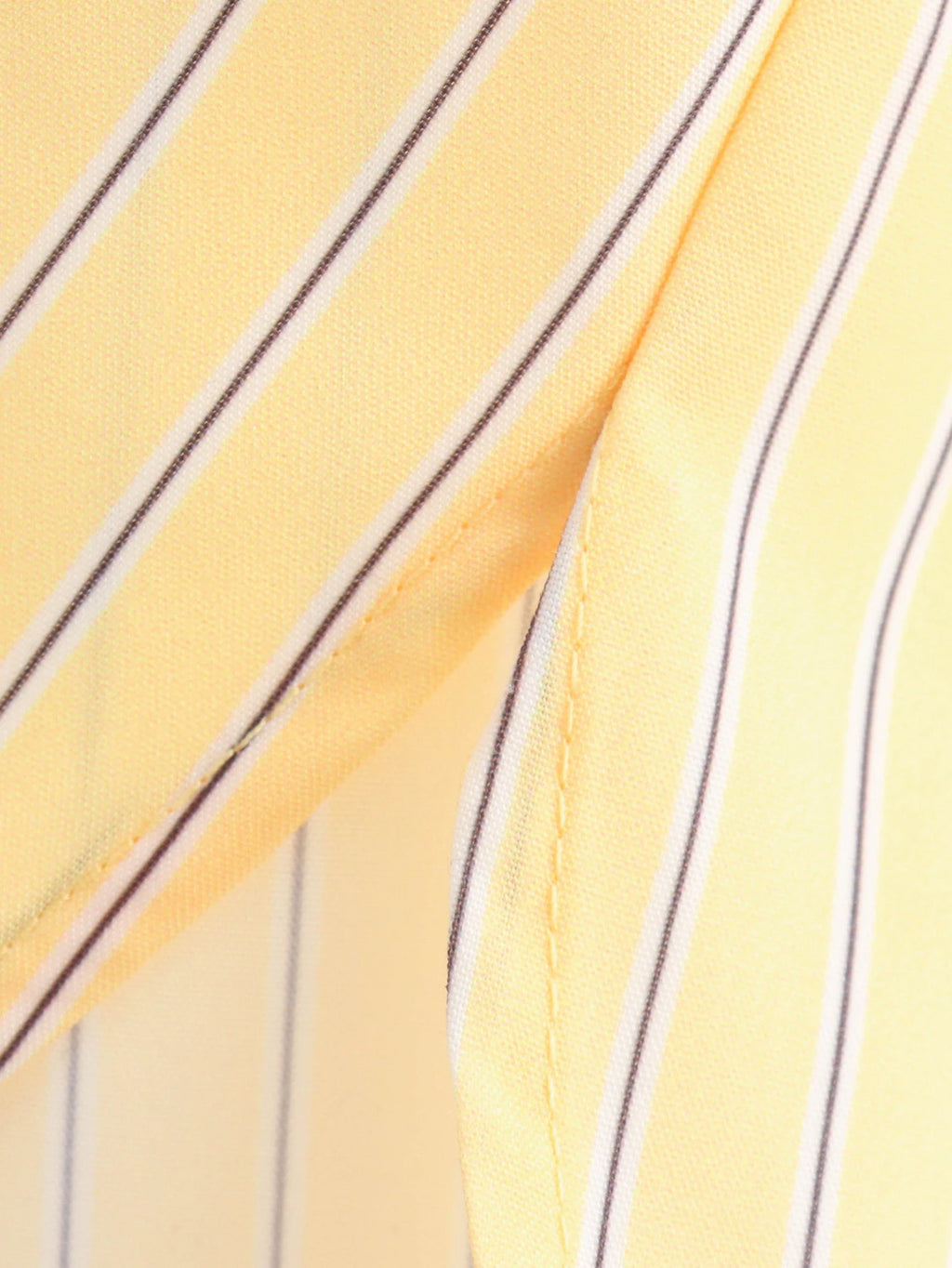 Close-up of yellow fabric with black stripes