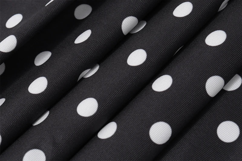 Close-up of black fabric with white polka dots
