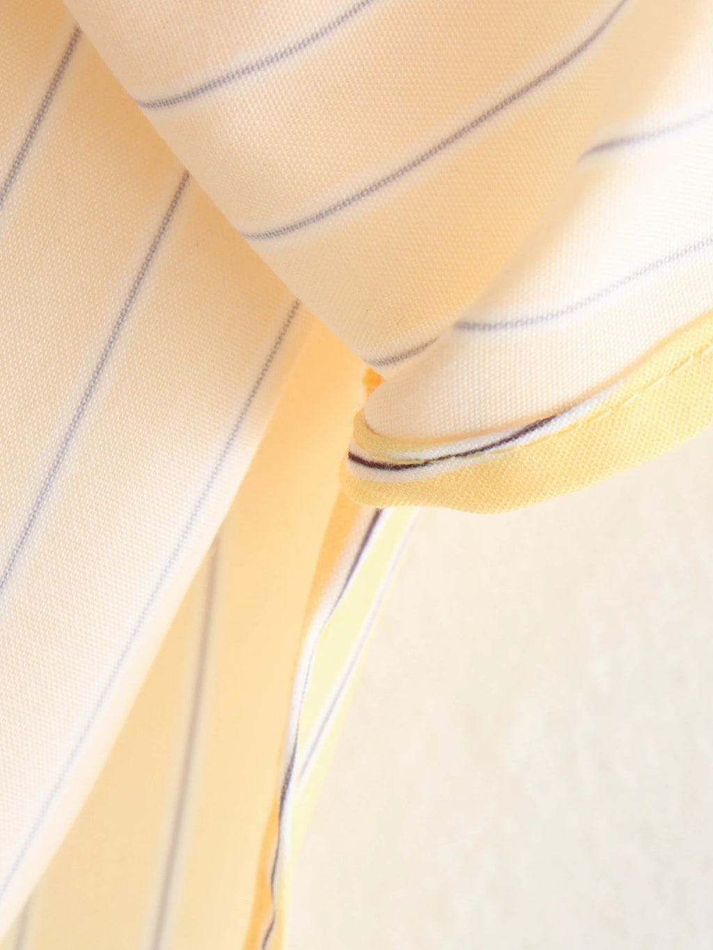 Close-up of yellow fabric with blue stripes