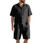 Man wearing a black pinstripe shirt and shorts on a white background