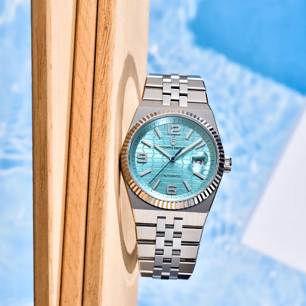 Silver watch with a blue face on a wooden surface with a blue background