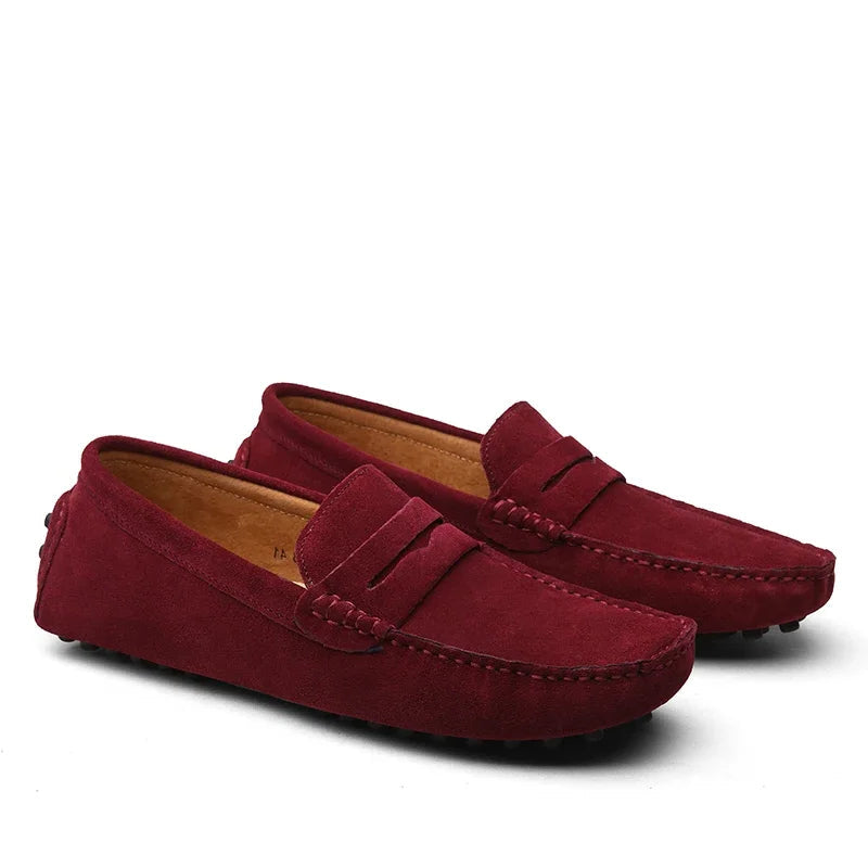 Pair of red loafers on a white background