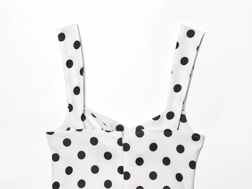White top with black polka dots on a white background