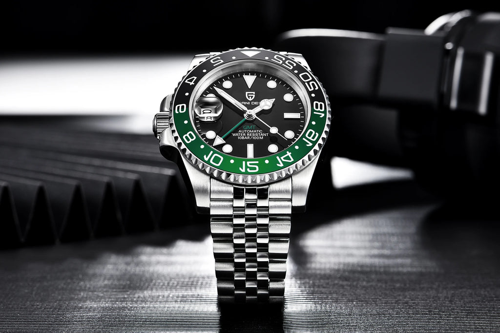 Luxury watch with black face and green bezel on a dark background
