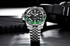 Luxury watch with black face and green bezel on a dark background