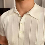 Man wearing the Cannes ribbed polo with white trousers at a seaside resort.