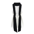 White sleeveless top with black scarf draped over shoulders on a white background