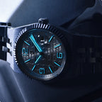 Watch with blue glowing hands on a dark background