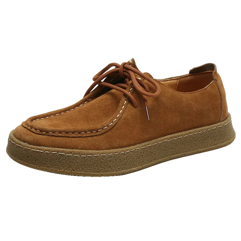 Brown suede shoe on a white background