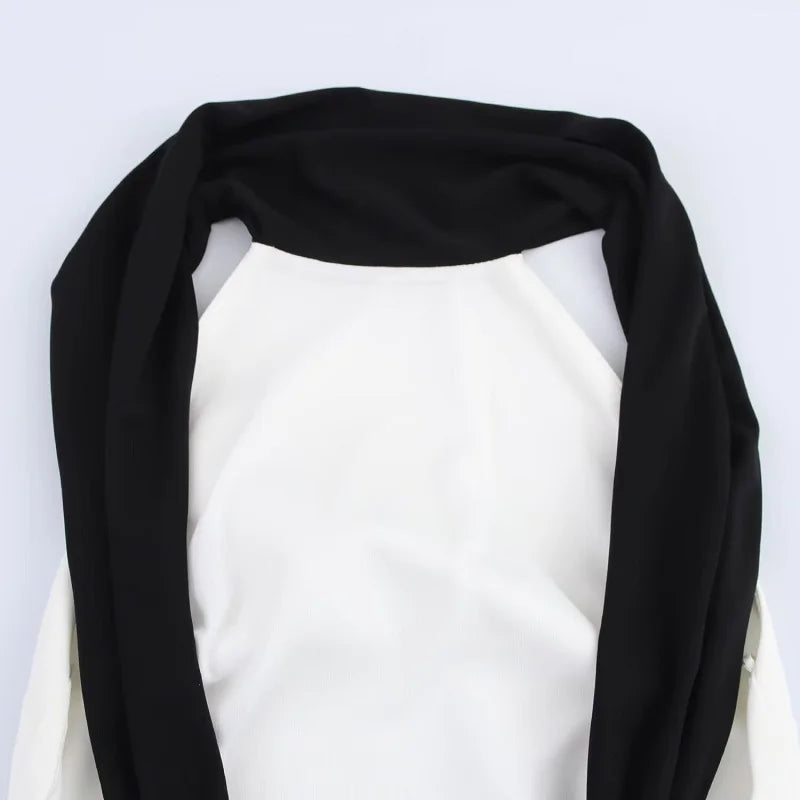 Black scarf draped over a white background