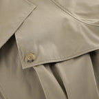 Close-up of a beige trench coat with a button