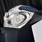 Watch with blue strap and visible mechanical components on a dark background