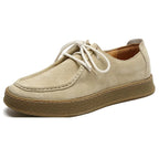 Beige suede shoe with white laces on a white background