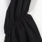 Black scarf draped over a mannequin on a white background