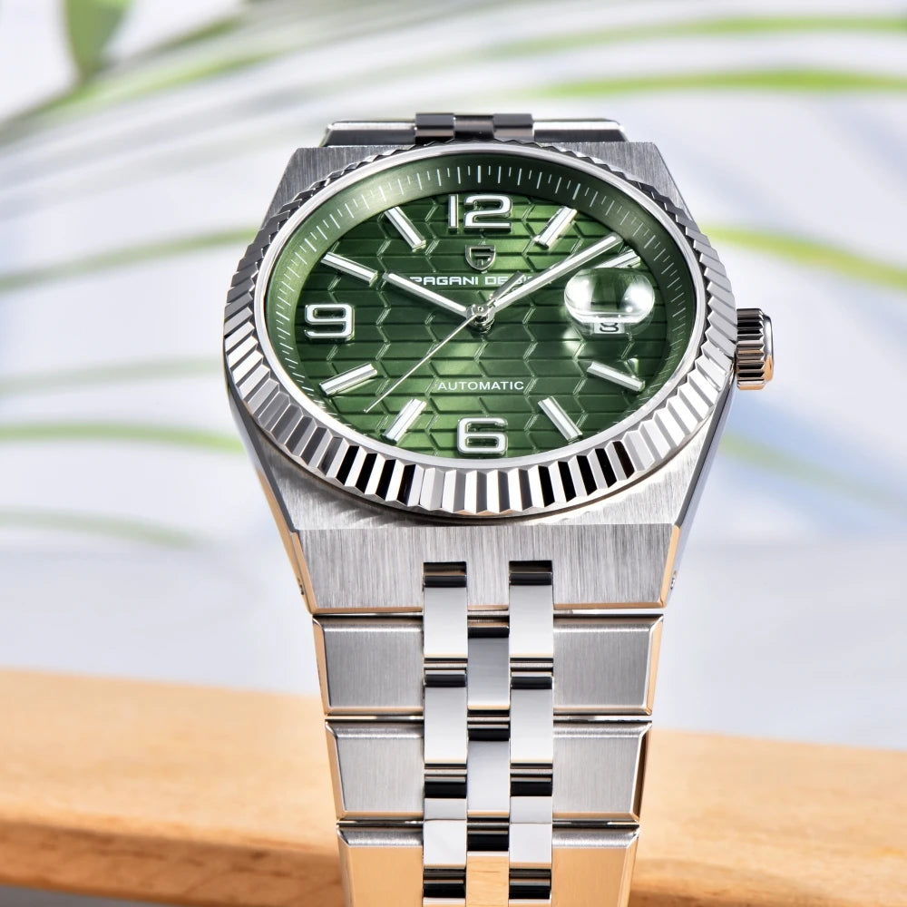 Silver watch with green dial on a wooden surface