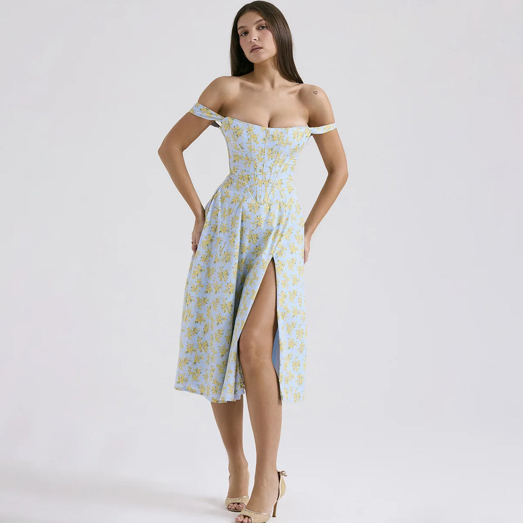Woman wearing a light blue floral off-shoulder dress with a slit on a white background