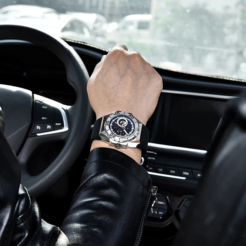 Person wearing a watch inside a car with a blurred background