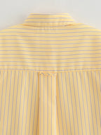 Close-up of a yellow striped shirt with a plain background