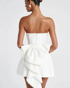 White strapless dress with a bow detail on a white background