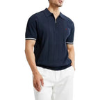 Man wearing a navy blue polo shirt with white trim on a white background