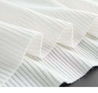 Close-up of white fabric with a subtle pattern