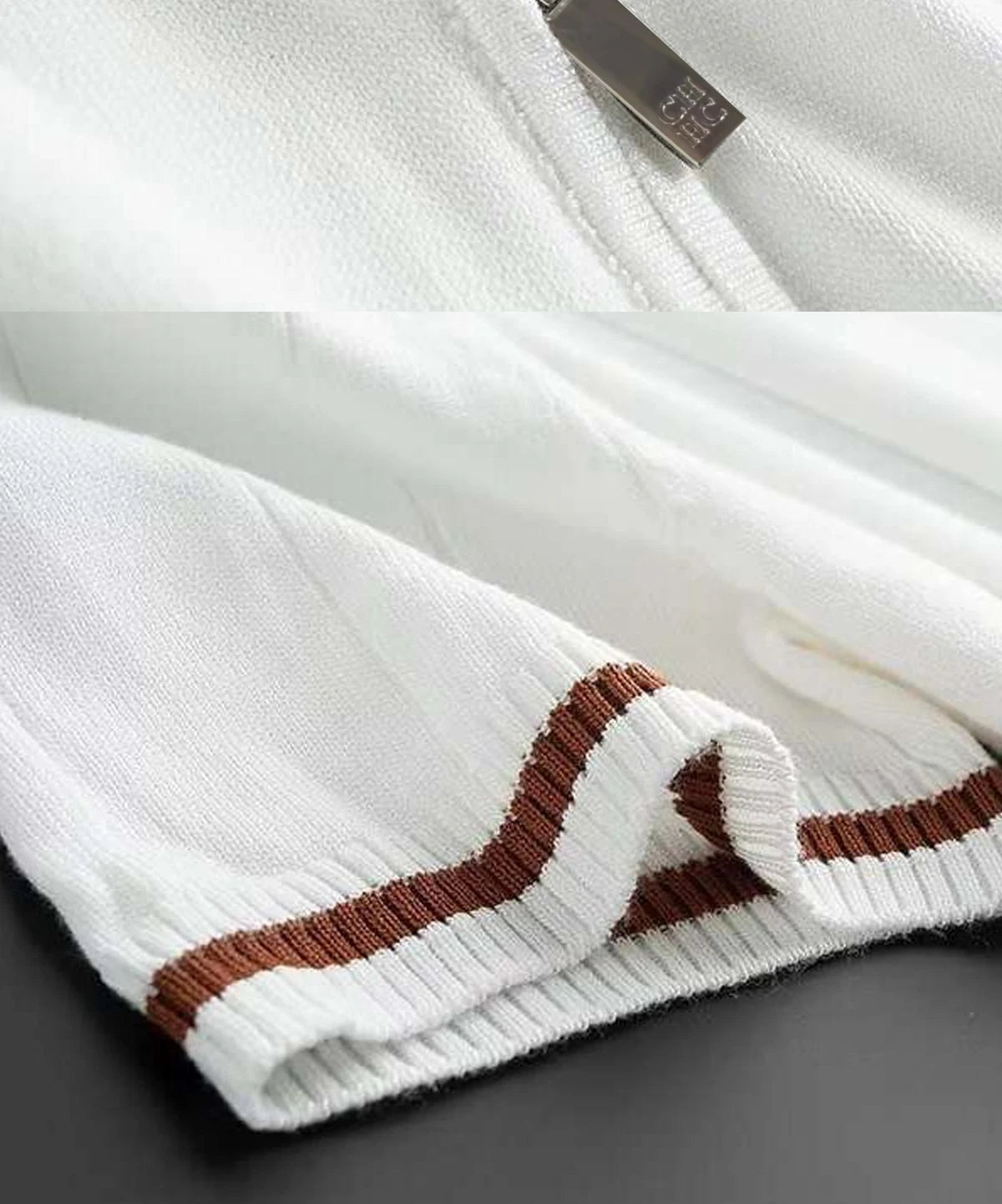 Close-up of a white sweater with brown ribbed pattern on a dark surface