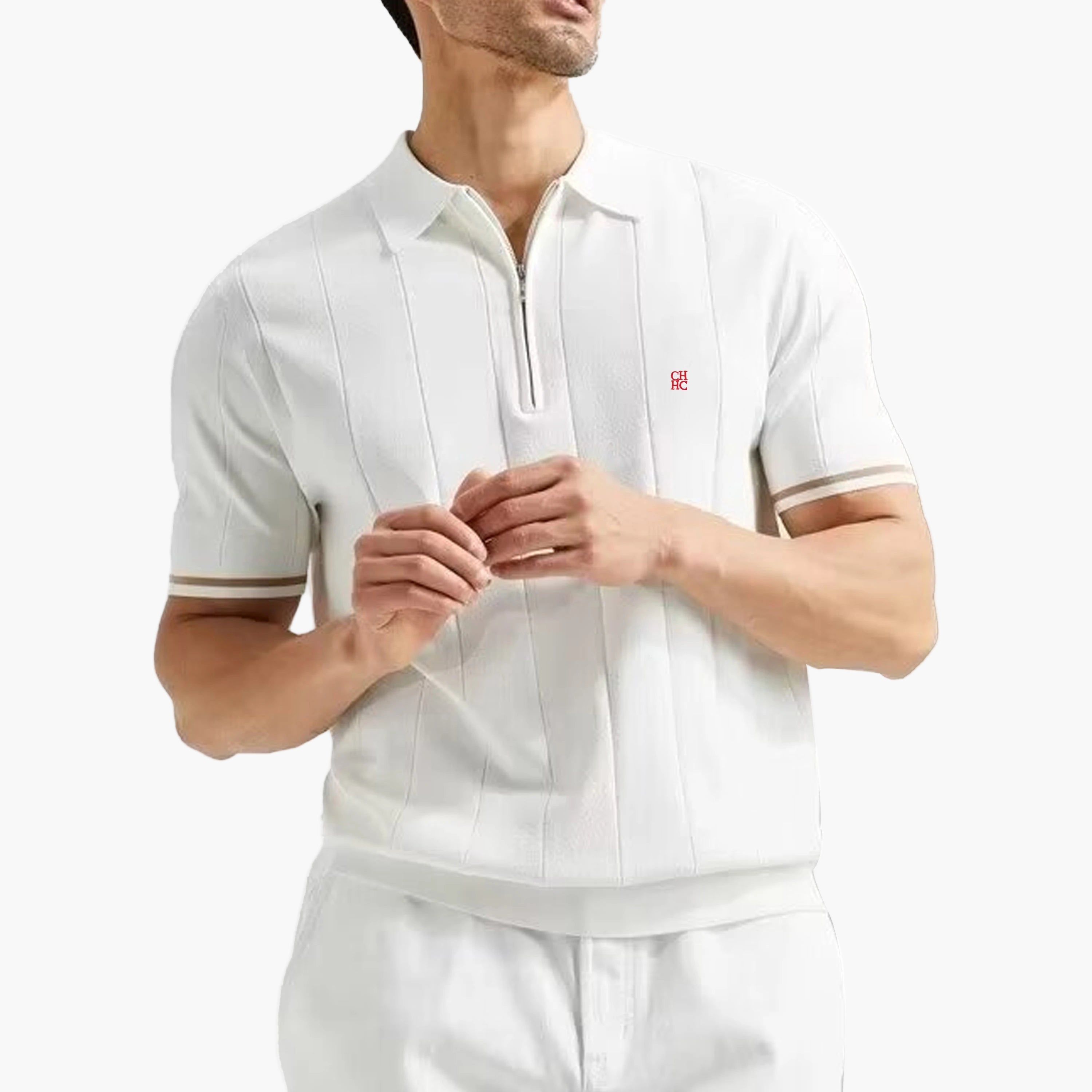 Man wearing a white polo shirt with a small red logo on a white background
