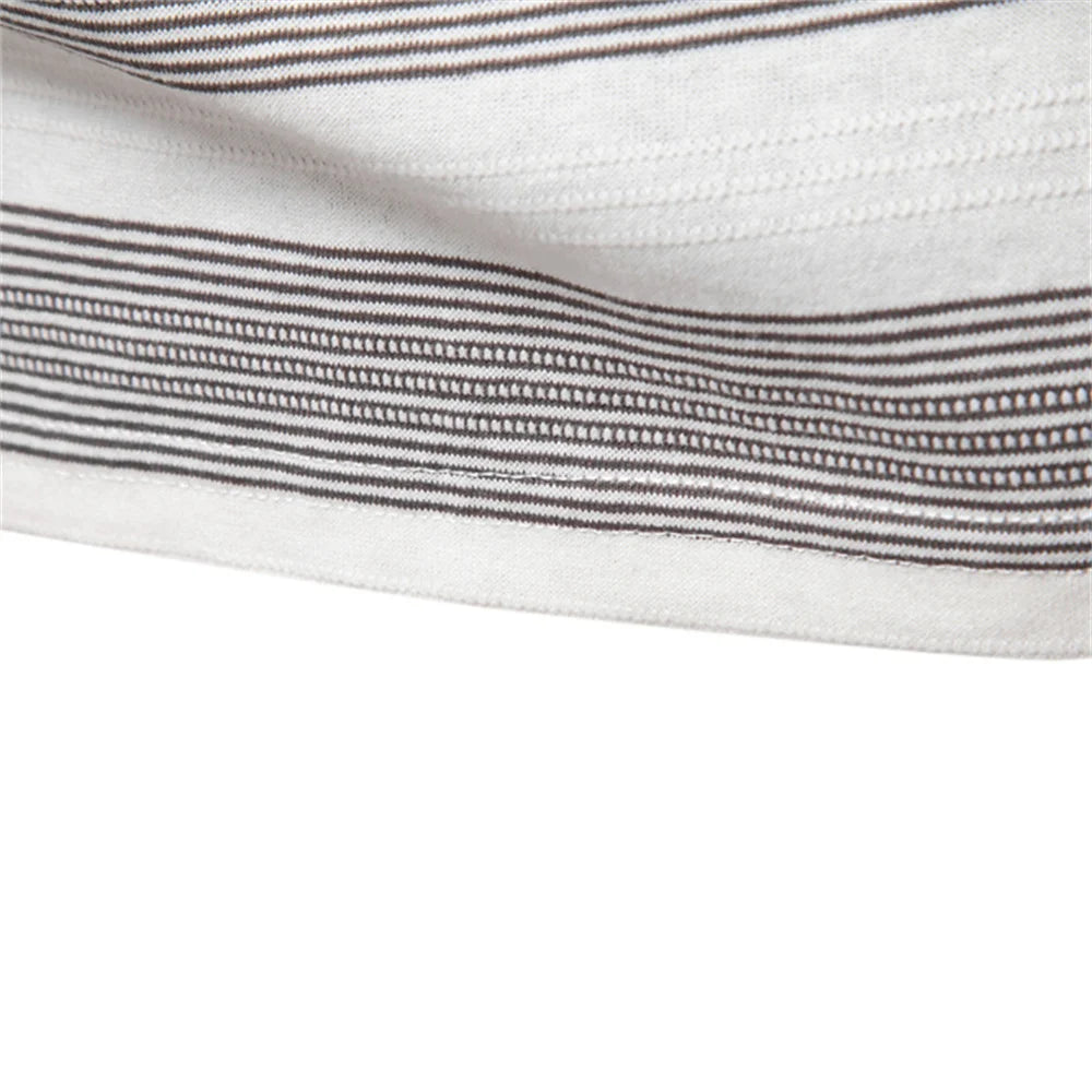 Close-up of a white fabric with thin black stripes on a white background